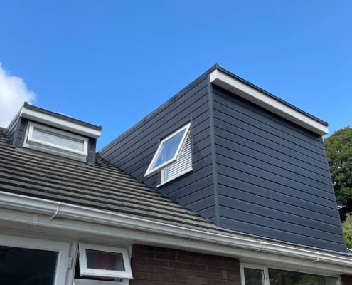 Completed loft conversion exterior with dark cladded dormer, by Astro Building Services in South Wales